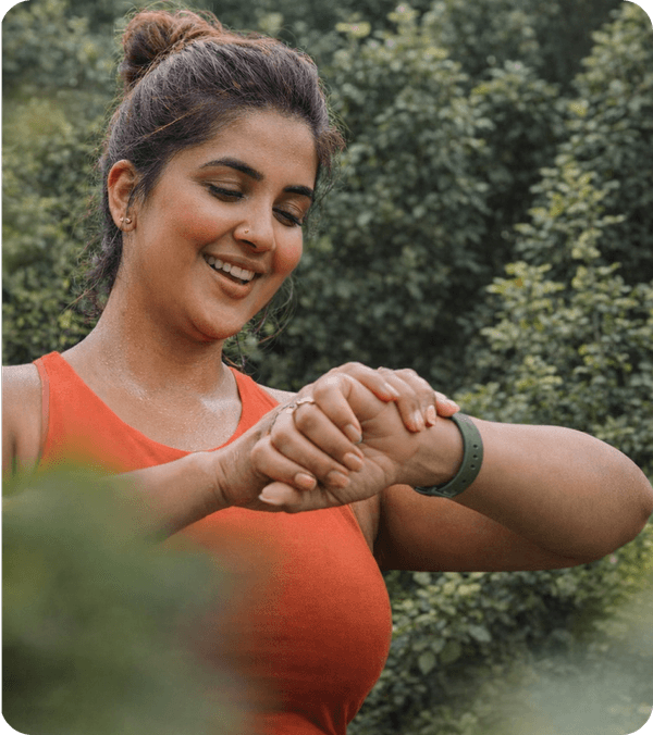 Woman checking her fitness tracker outdoors